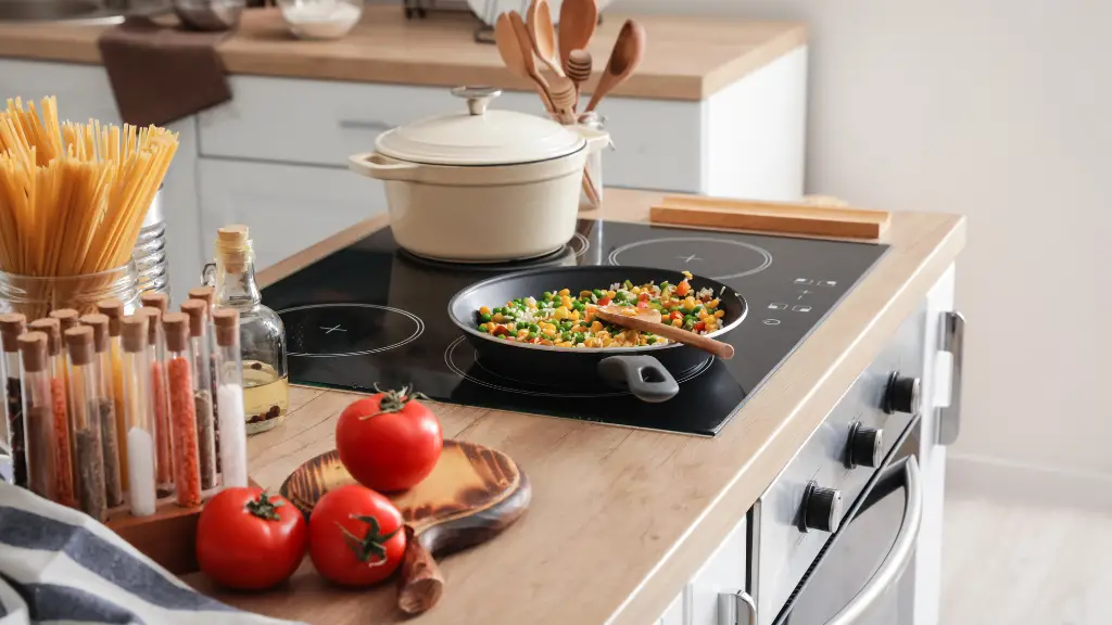 modern electric stove with kitchen utensils