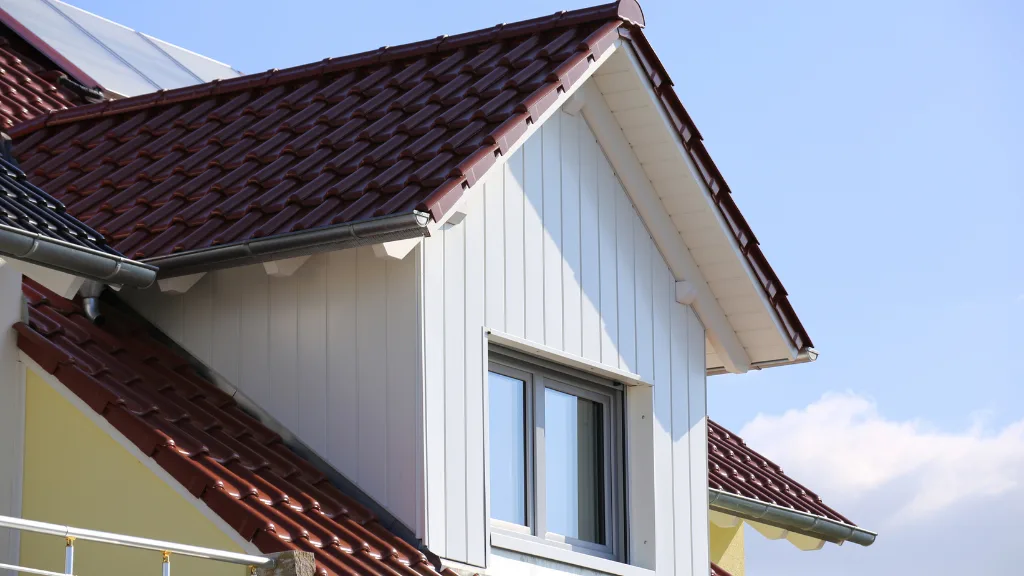 Tiled roof with wooden cladded dormer