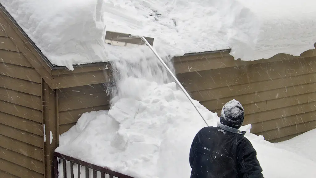 man removing snow from roof