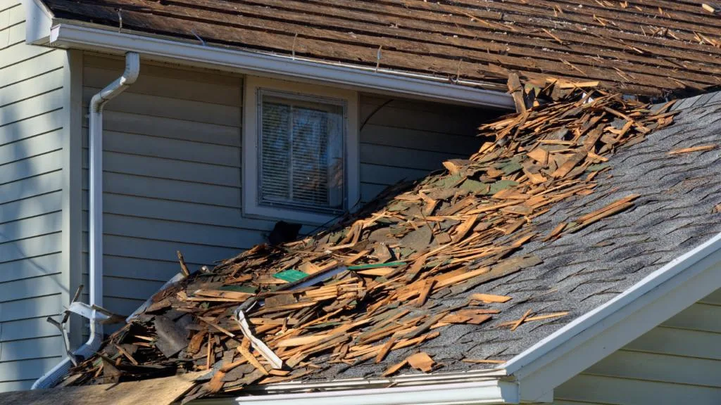 roofers tearing off roof